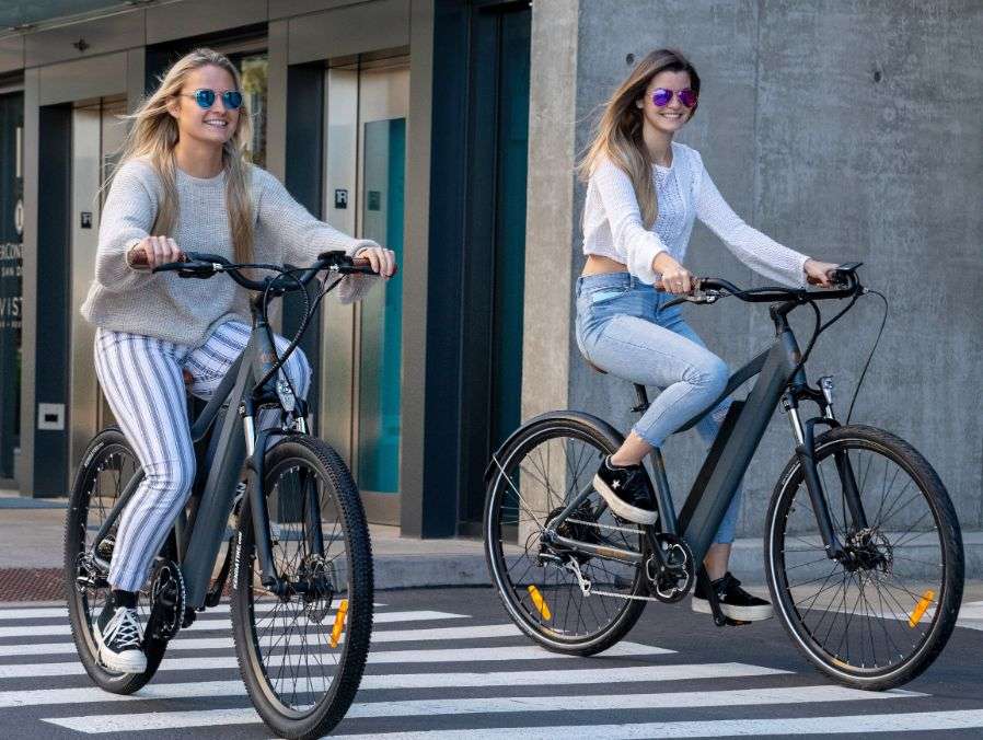 two women riding ride1up electric bikes