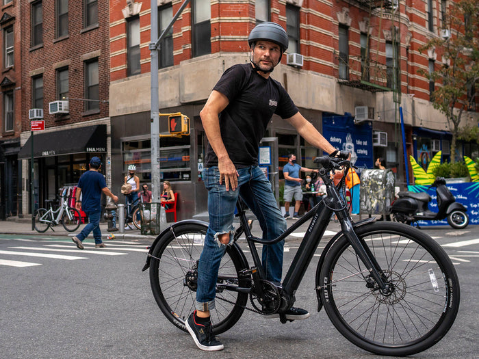 man riding priority current electric bicycle